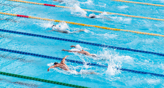 Ein Schwimmbecken mit Schwimmerinnen und Schwimmern im Wettkampf / Foto: Serena Repice Lentini on Unsplash