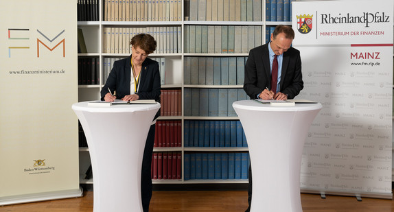 Baden-Württembergs Finanzstaatssekretärin Gisela Splett (links) und Stephan Weinberg, Staatssekretär im Ministerium der Finanzen von Rheinland-Pfalz, bei der Unterzeichnung der Vereinbarung. / Foto: Oberfinanzdirektion Karlsruhe